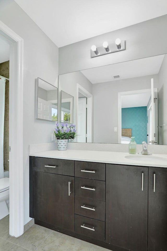 bathroom featuring vanity and toilet