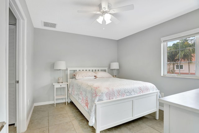 tiled bedroom with ceiling fan