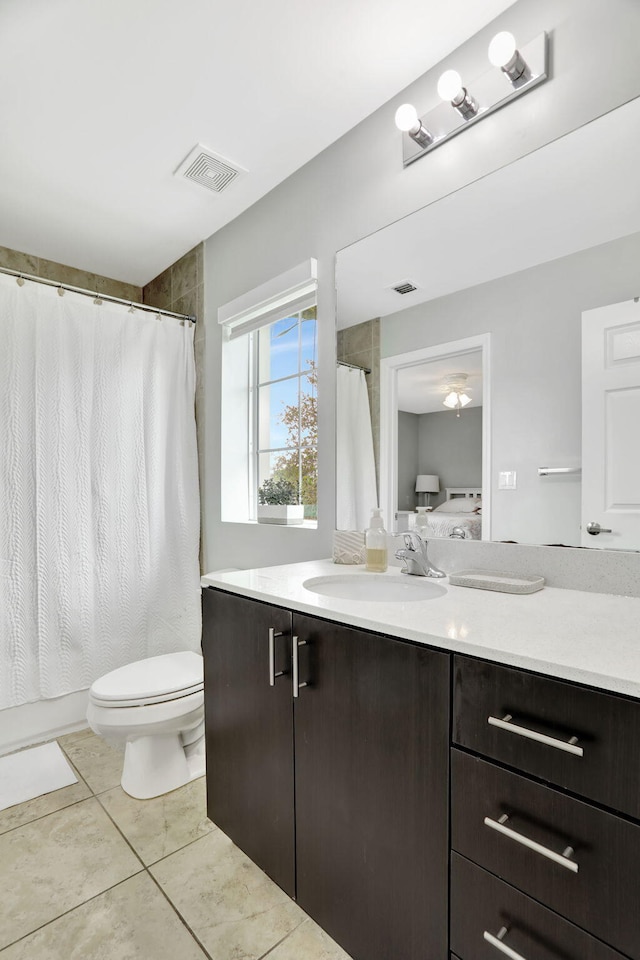 bathroom with tile patterned flooring, vanity, and toilet