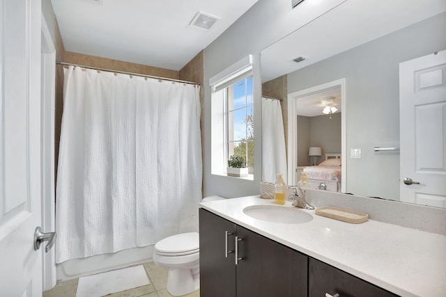 full bathroom featuring shower / bath combo with shower curtain, tile patterned flooring, vanity, and toilet