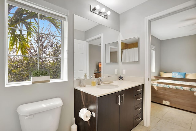 bathroom featuring tile patterned flooring, vanity, and toilet