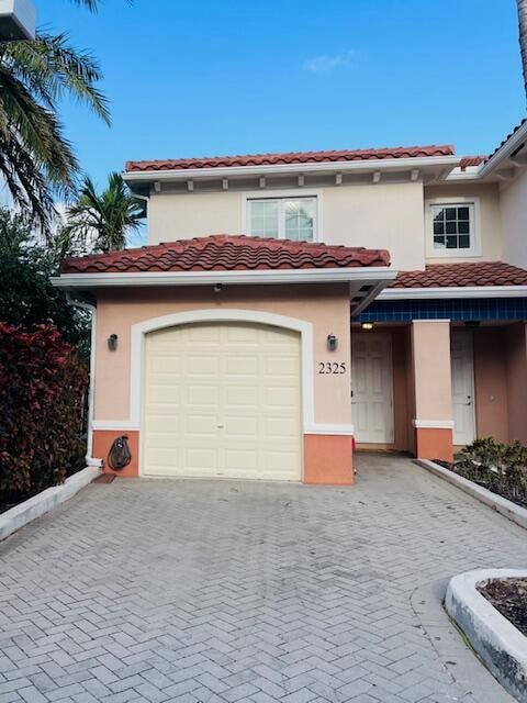 mediterranean / spanish house featuring a garage