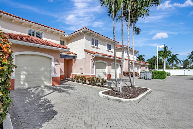 mediterranean / spanish-style house with a garage