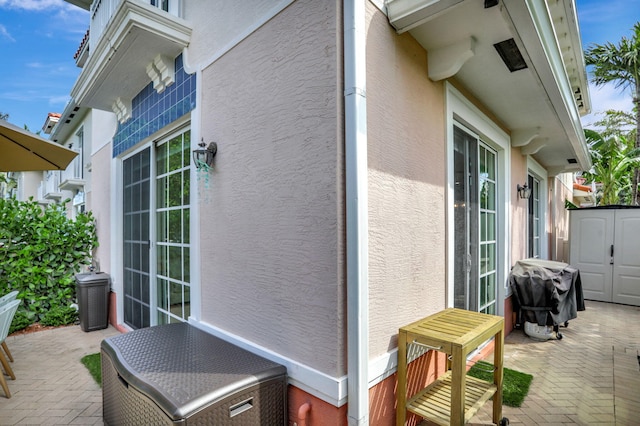 view of patio / terrace featuring a grill and a shed