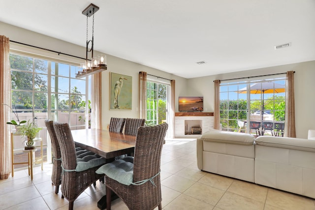 tiled dining space with a chandelier