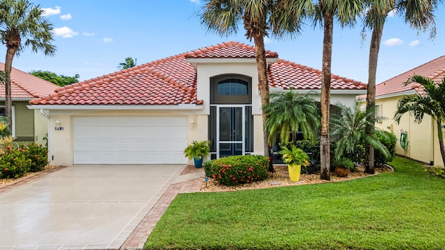 mediterranean / spanish home featuring a front lawn and a garage