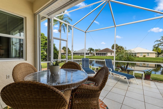 view of patio / terrace with glass enclosure and a water view