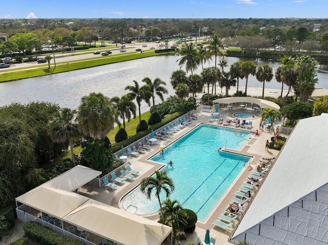 view of pool with a water view and a patio area