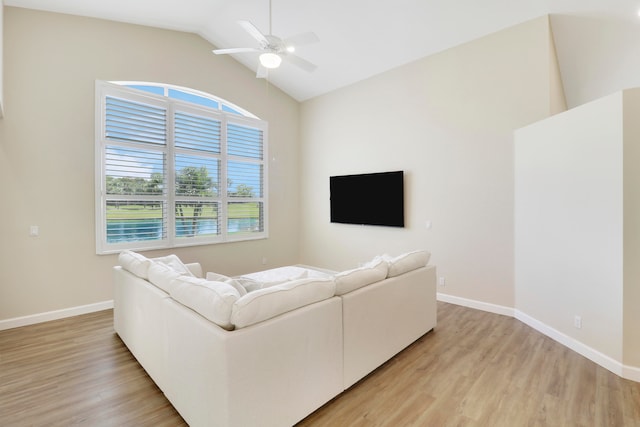 living room with light hardwood / wood-style floors, lofted ceiling, and ceiling fan