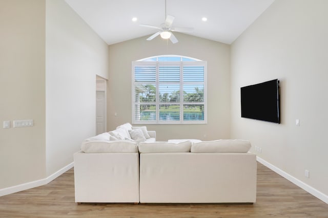 living room featuring lofted ceiling, light hardwood / wood-style floors, and ceiling fan