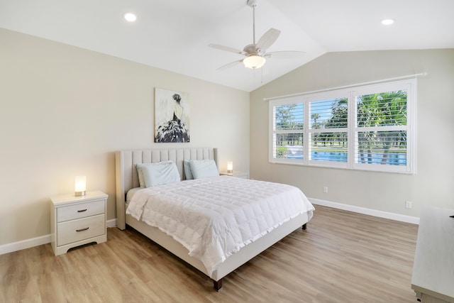 bedroom featuring light hardwood / wood-style flooring, vaulted ceiling, and ceiling fan