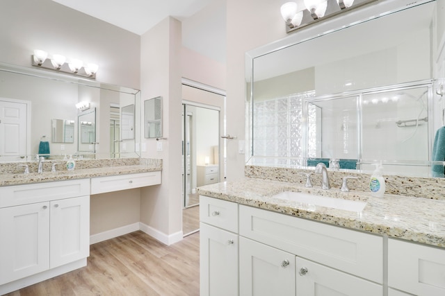 bathroom with vanity, hardwood / wood-style flooring, and walk in shower