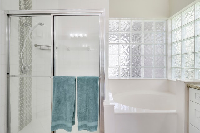 bathroom featuring vanity and shower with separate bathtub