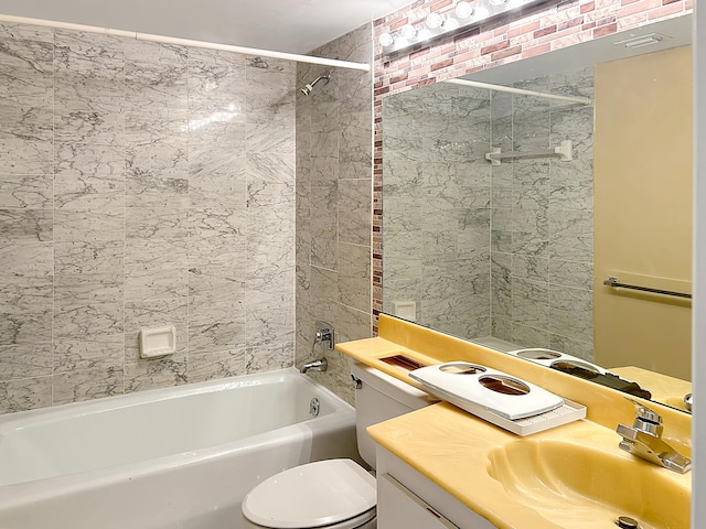 full bathroom featuring toilet, vanity, and tiled shower / bath