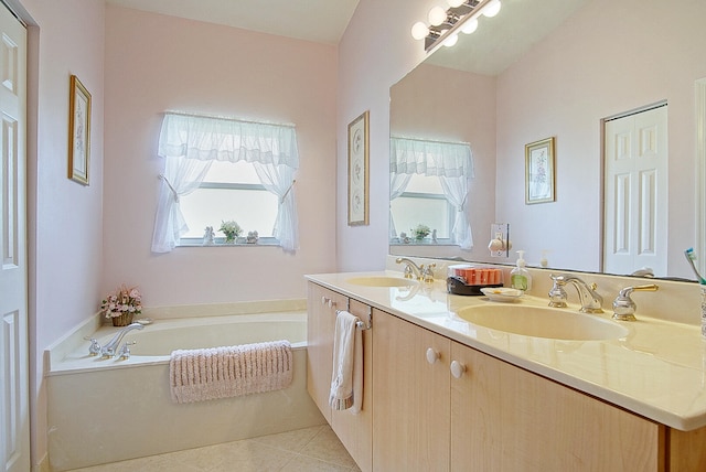 bathroom with vanity, plenty of natural light, tile patterned flooring, and a bath