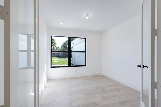 unfurnished room with light wood-type flooring