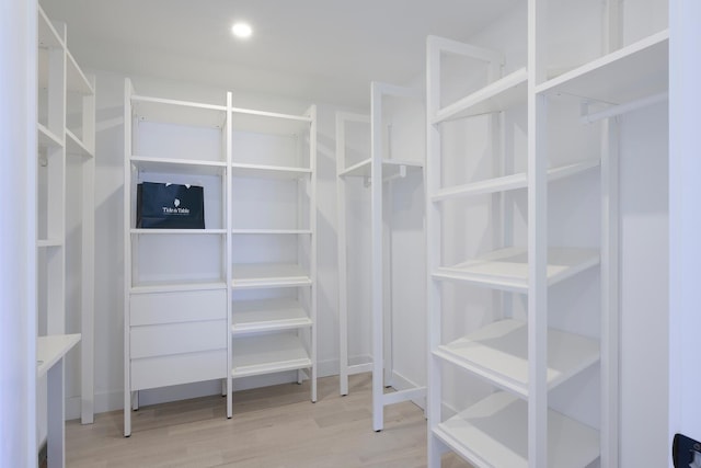 spacious closet with light hardwood / wood-style floors