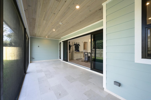 unfurnished sunroom with wooden ceiling