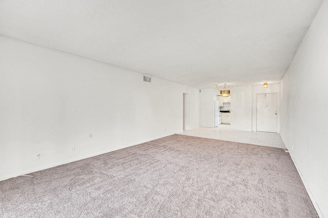 unfurnished living room with carpet flooring