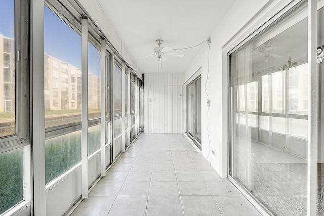 unfurnished sunroom with a wealth of natural light and ceiling fan