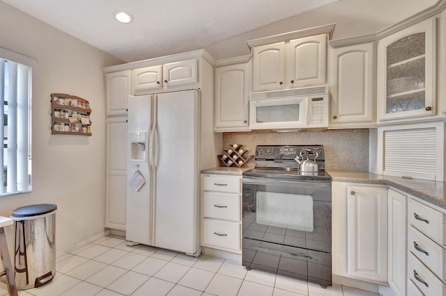 kitchen featuring glass insert cabinets, light tile patterned floors, decorative backsplash, recessed lighting, and white appliances