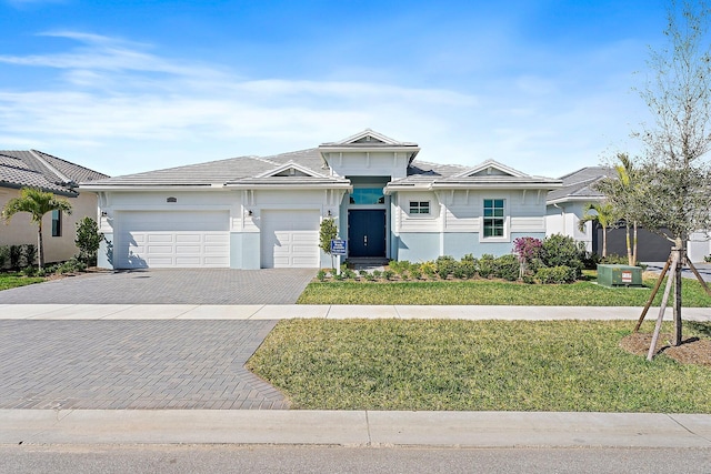 ranch-style house featuring a garage and a front yard