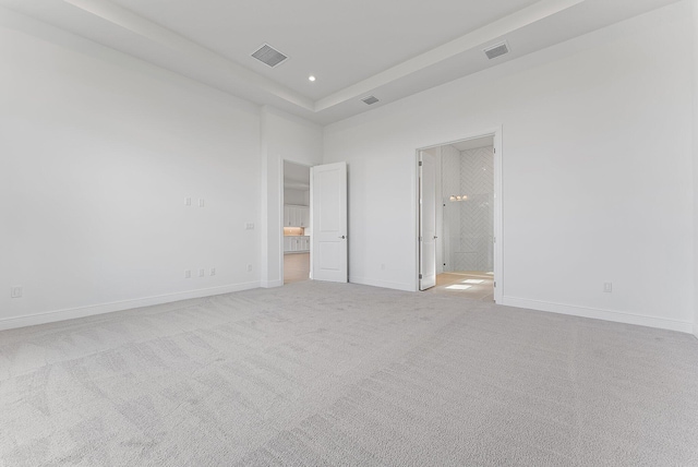 unfurnished bedroom with light colored carpet and ensuite bath