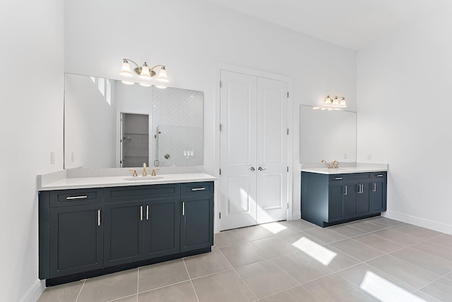 bathroom featuring tile patterned flooring, vanity, and walk in shower