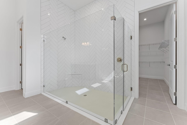 bathroom featuring a shower with shower door and tile patterned flooring