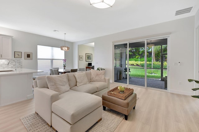 living room featuring light hardwood / wood-style flooring and plenty of natural light