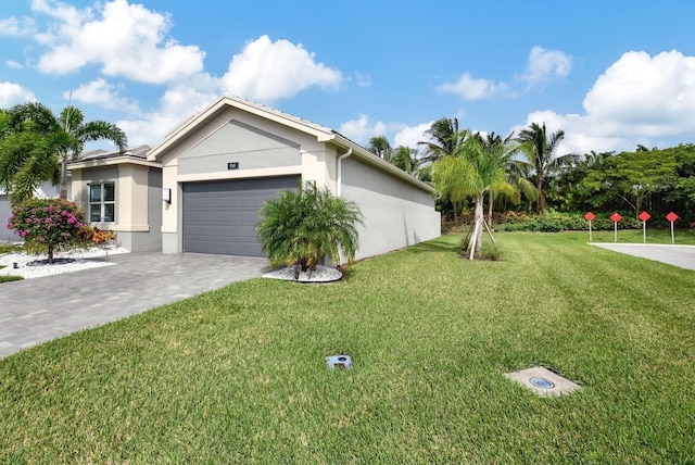 ranch-style home featuring a front lawn and a garage