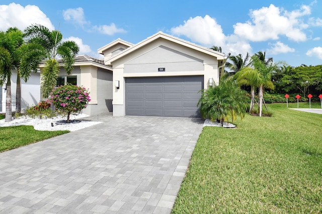 view of front of house with a front yard and a garage