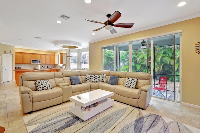 tiled living room featuring ornamental molding and ceiling fan