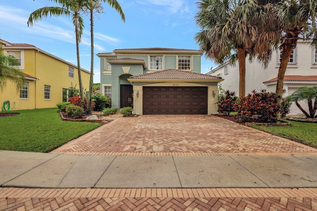 mediterranean / spanish-style home with a front lawn and a garage