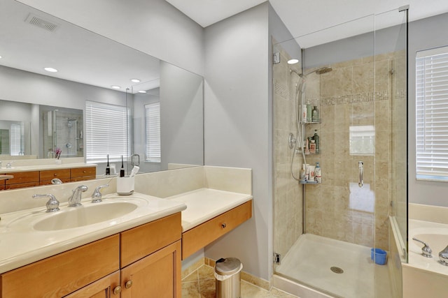 bathroom with tile patterned flooring, vanity, and independent shower and bath