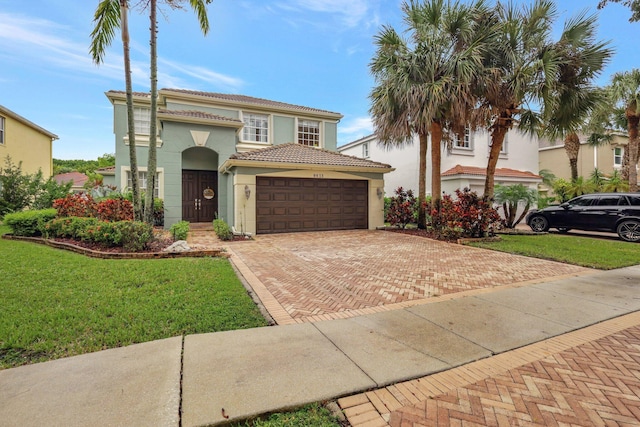 mediterranean / spanish-style house with a front yard and a garage