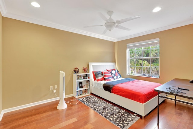 bedroom with ceiling fan, crown molding, and wood-type flooring