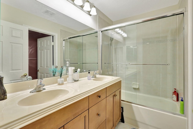 bathroom with vanity and enclosed tub / shower combo