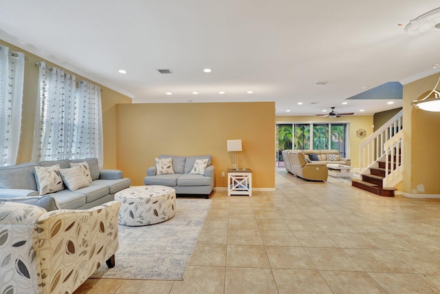 living room with ceiling fan, crown molding, and light tile patterned floors