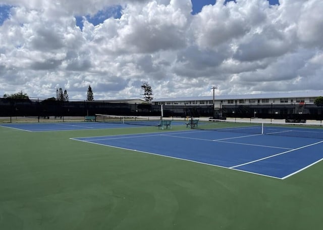 view of tennis court with basketball hoop