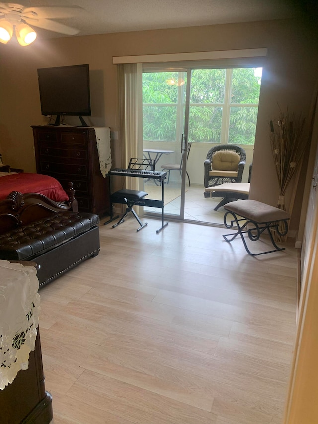 bedroom with light hardwood / wood-style floors and multiple windows