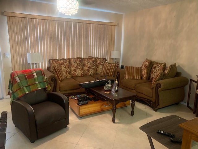 tiled living room featuring a chandelier