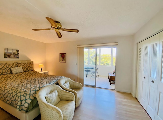 bedroom featuring ceiling fan, access to outside, a textured ceiling, light hardwood / wood-style floors, and a closet