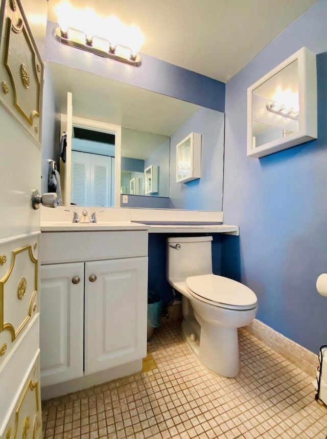 bathroom featuring vanity, toilet, and tile patterned flooring