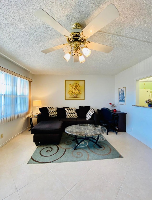 tiled living room with a textured ceiling and ceiling fan