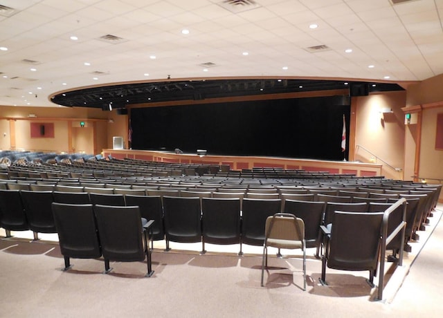 cinema featuring light colored carpet