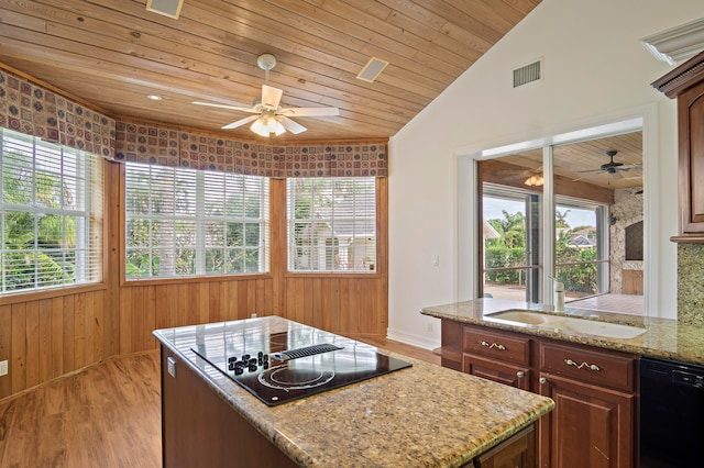 kitchen featuring black appliances, sink, light stone counters, wooden ceiling, and light hardwood / wood-style flooring