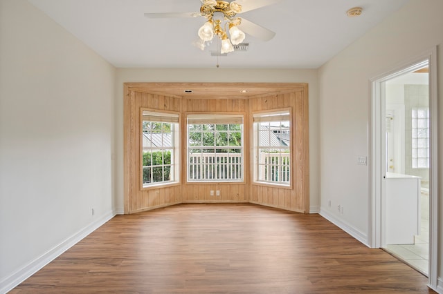 spare room with hardwood / wood-style flooring and ceiling fan