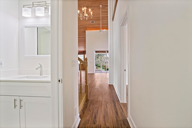 hallway with sink and dark wood-type flooring