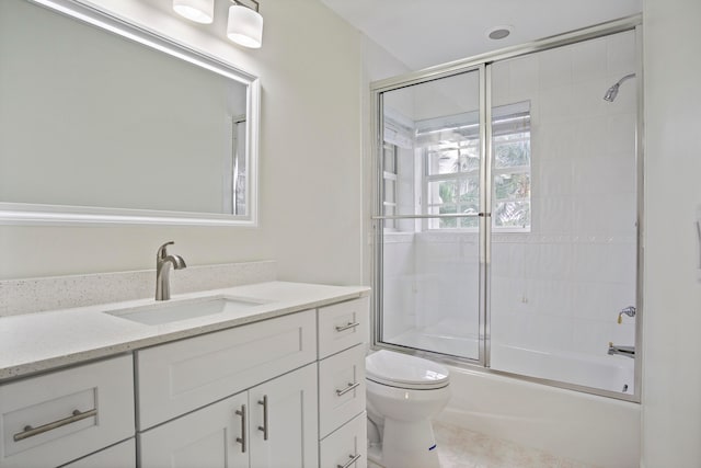 full bathroom featuring toilet, shower / bath combination with glass door, tile patterned floors, and vanity